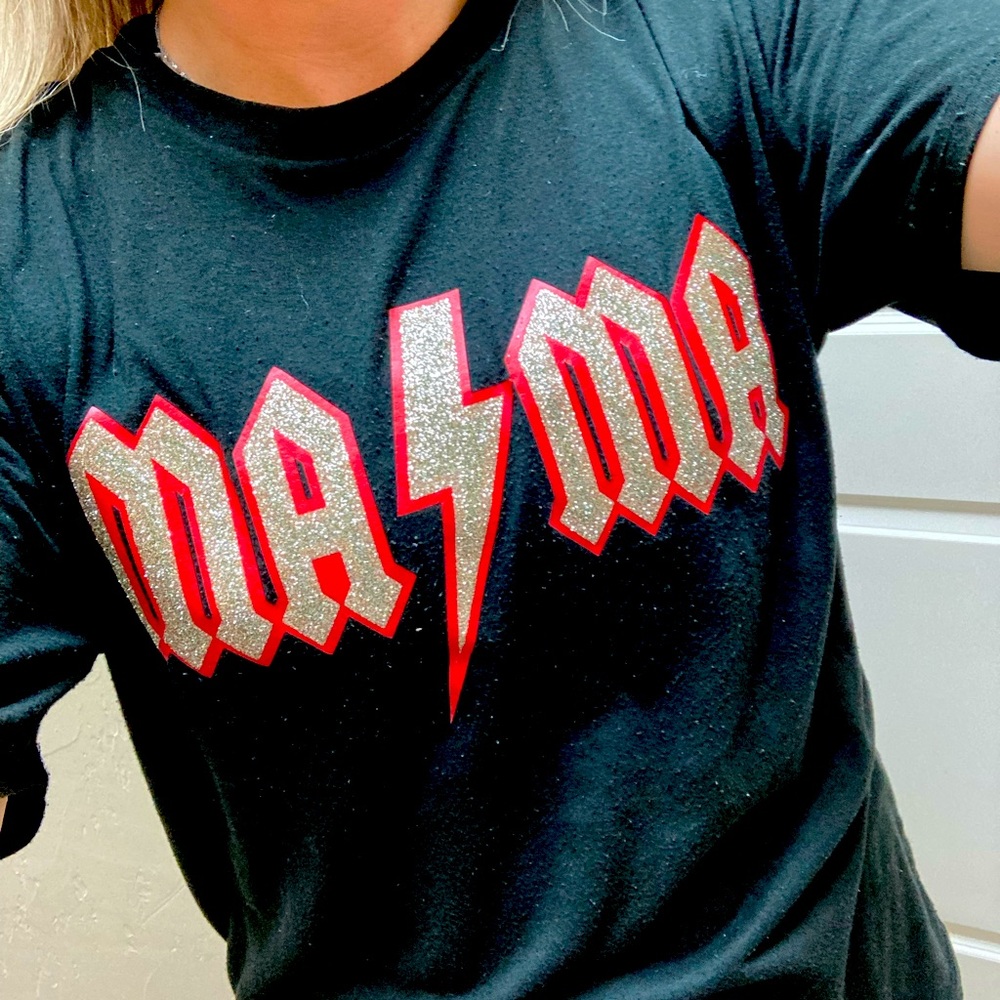 Bella canvas black short sleeve shirt MAMA glitter with red background.
